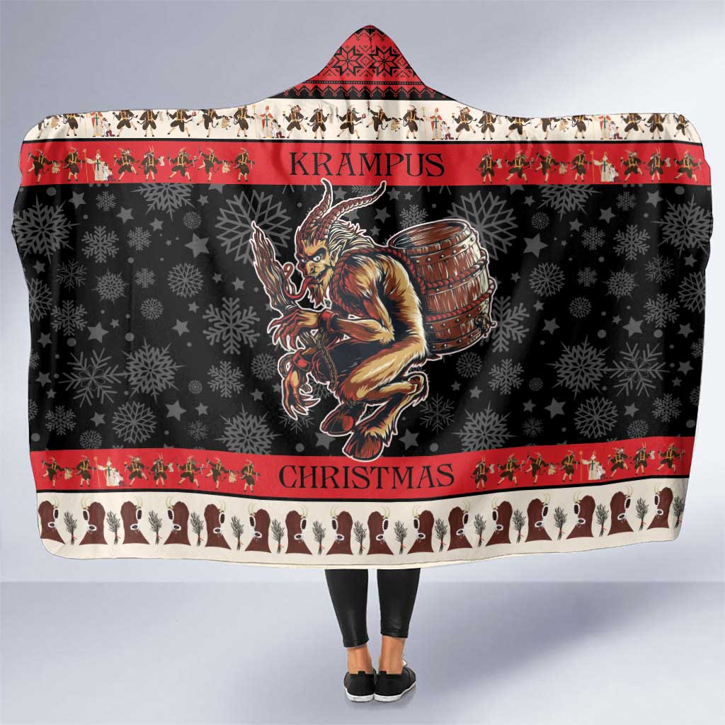 Red and black hooded blanket with devil graphic, drum, and snowflake border