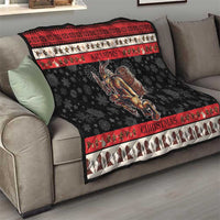 Krampus Christmas quilt blanket on couch with red trim and central demon rider artwork