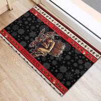 Red and black rubber Krampus Christmas doormat with snowflakes and striped border