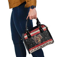 Black Krampus Christmas handbag with red trim and shoulder strap, shown held at hip level