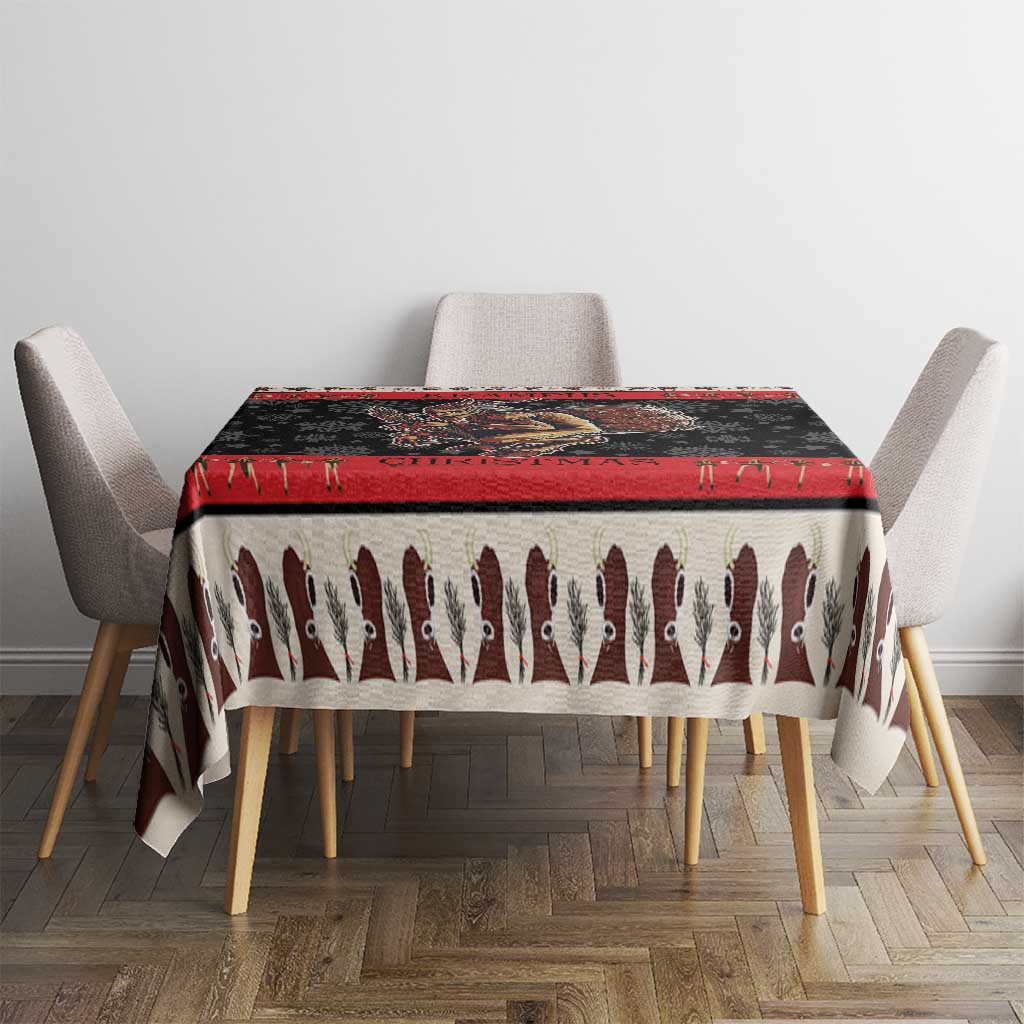 Krampus-themed Christmas tablecloth draped over table, red top border and devil print