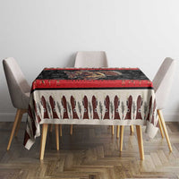 Krampus-themed Christmas tablecloth draped over table, red top border and devil print