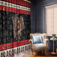 Black and red Krampus Christmas window curtains framing a living room chair and window