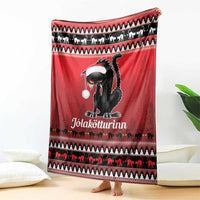 Red Iceland blanket featuring a black cat face with white hat and holiday animal stripe borders