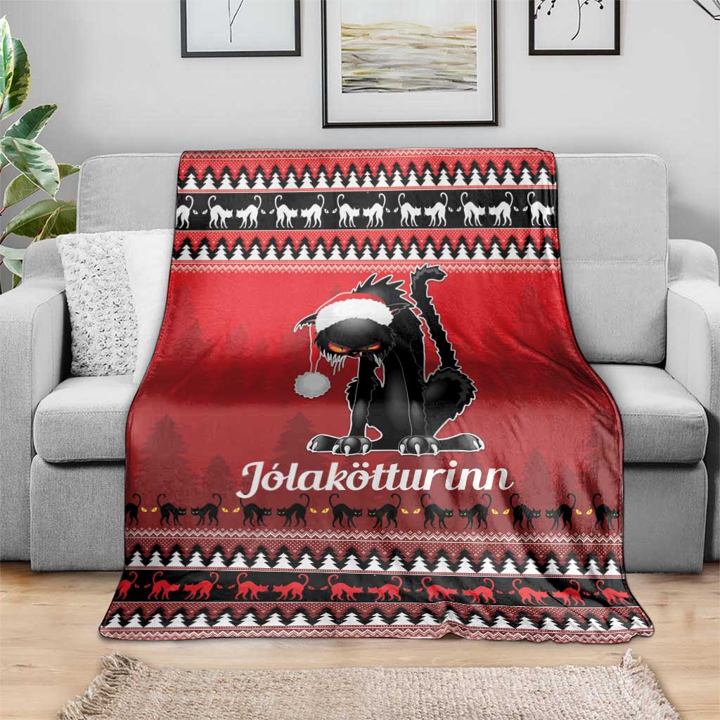 Red Iceland blanket throw with black cat wearing a white hat on a sofa, patterned holiday trim