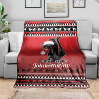 Red Iceland blanket throw with black cat wearing a white hat on a sofa, patterned holiday trim