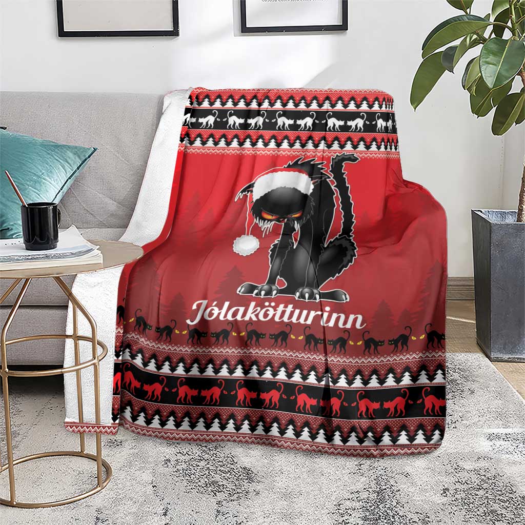 Red Iceland blanket throw with black cat and white hat, displayed over a gray rug