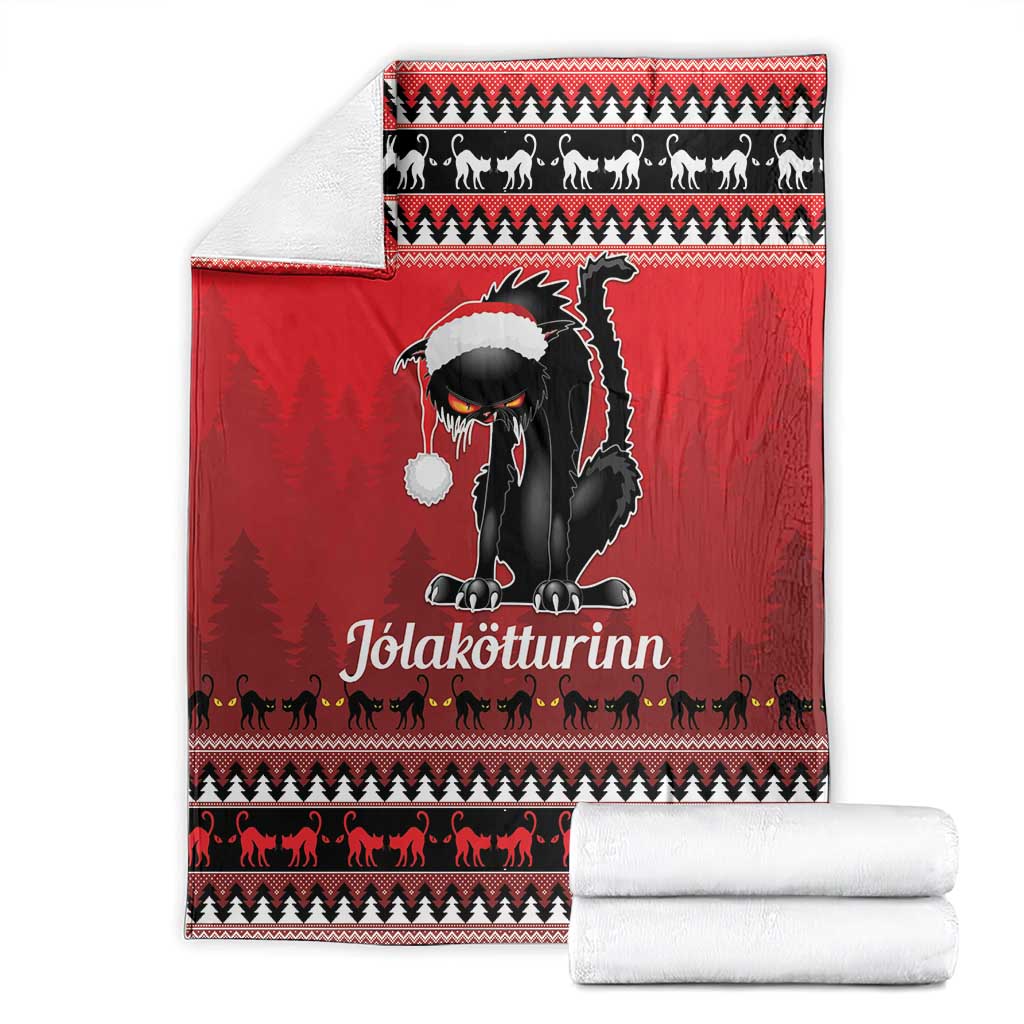 Red Iceland blanket with black cat centerpiece, white hat, and set with rolled white towels