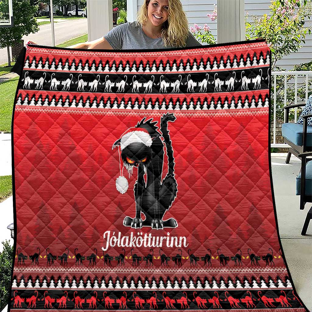 Red quilt blanket with black cat graphic and festive patterned border