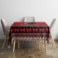 Red Christmas tablecloth with black animal silhouette band and geometric trim