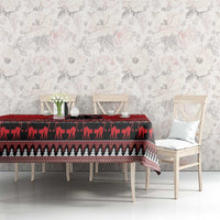 Red Christmas tablecloth with black cat silhouettes and patterned hem over table