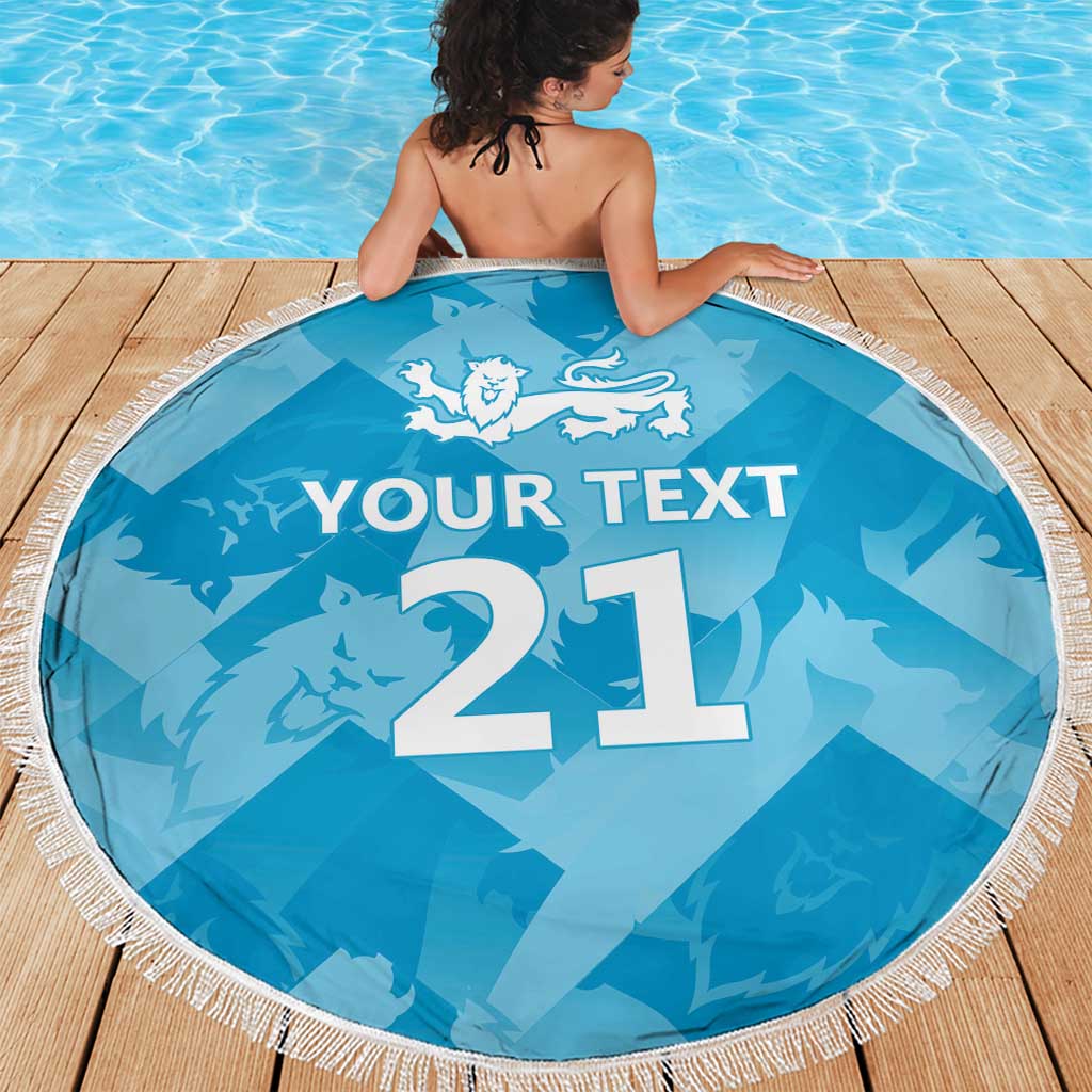 Blue round beach blanket with tassel fringe, lion crest and '21' with 'YOUR TEXT' on deck.