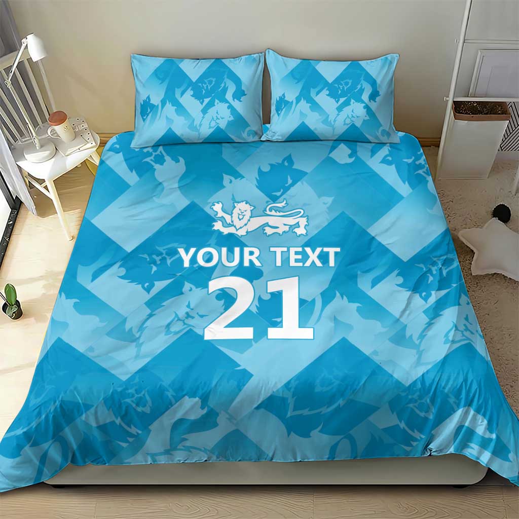 Blue bedding set featuring “YOUR TEXT 21” text and lion crest on duvet and pillows