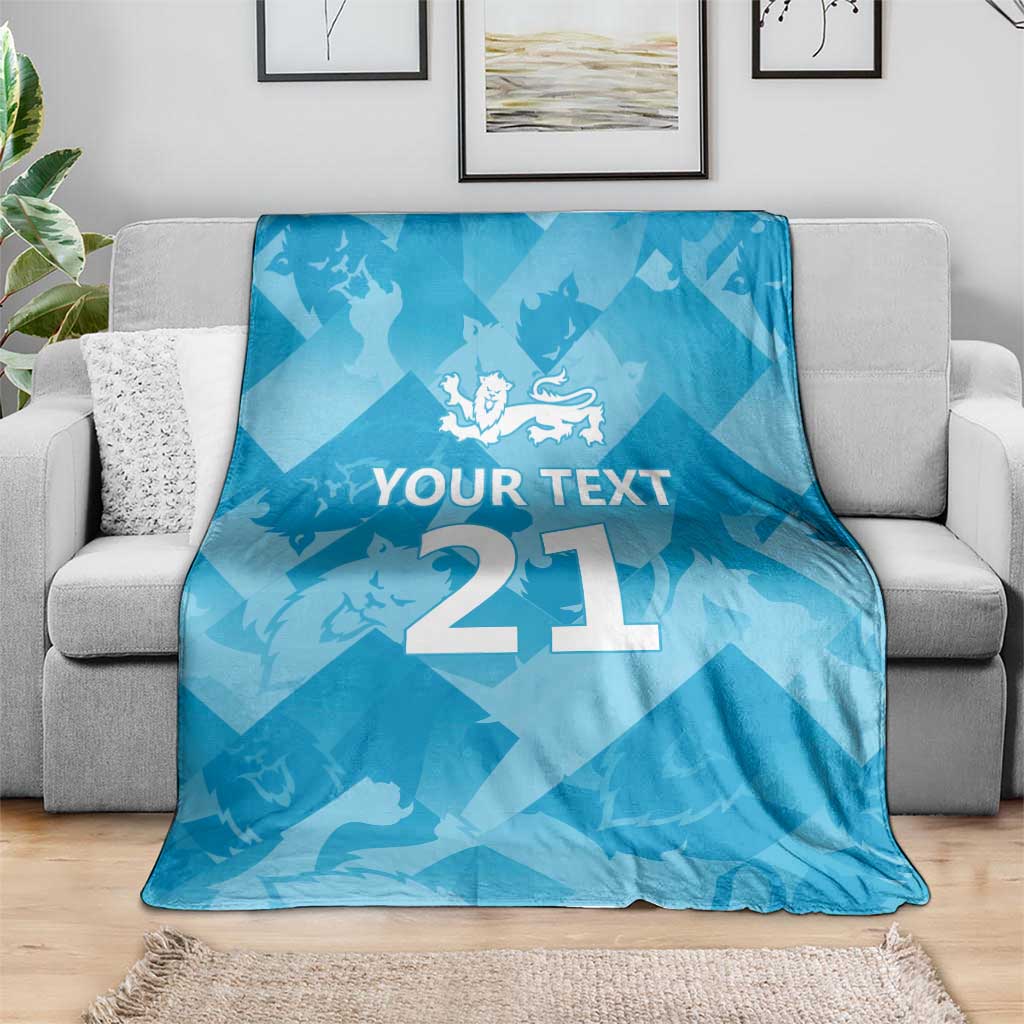 Blue custom cricket blanket spread on sofa with 'YOUR TEXT' and number 21