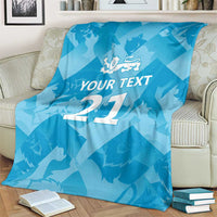 Blue custom cricket blanket on chair with lion emblem, 'YOUR TEXT', and number 27