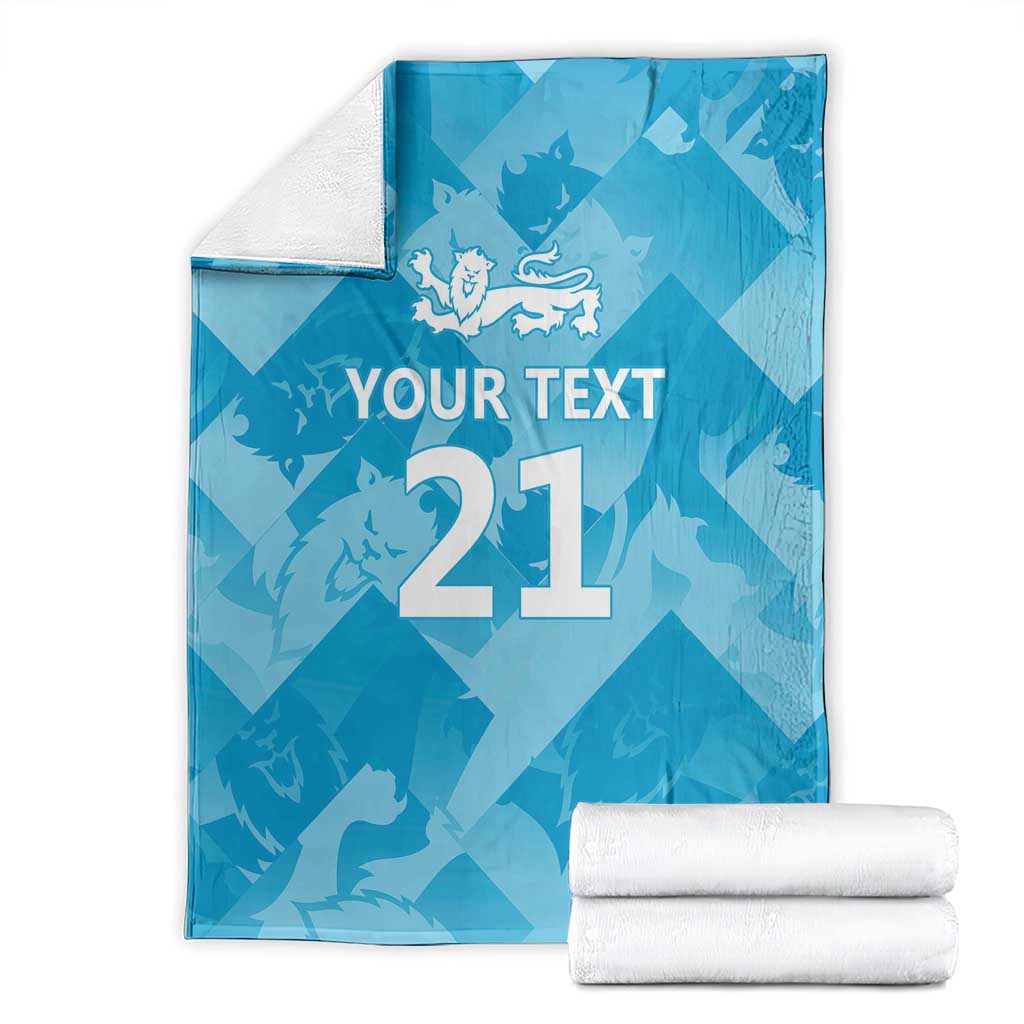 Blue custom cricket blanket with lion emblem, 'YOUR TEXT', number 21, and folded towels