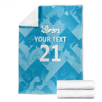 Blue custom cricket blanket with lion emblem, 'YOUR TEXT', number 21, and folded towels