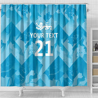 Blue shower curtain with lion crest and custom text 21, close-up bottom hem
