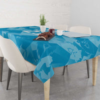 Blue tablecloth with lion silhouette pattern draped over a dining table