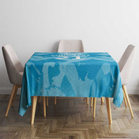 Blue tablecloth with lion silhouettes covering a small square dining table