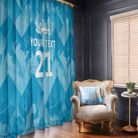 Blue window curtain with lions crest and custom text, draped over a rod.
