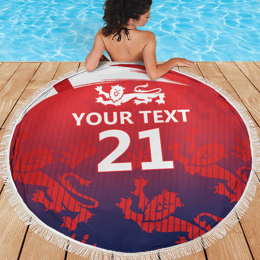 Round beach blanket with fringe, red and navy pattern, lion crest and “YOUR TEXT 21”