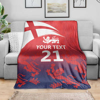 Red and dark blue cricket blanket with England flag and lion crest over sofa