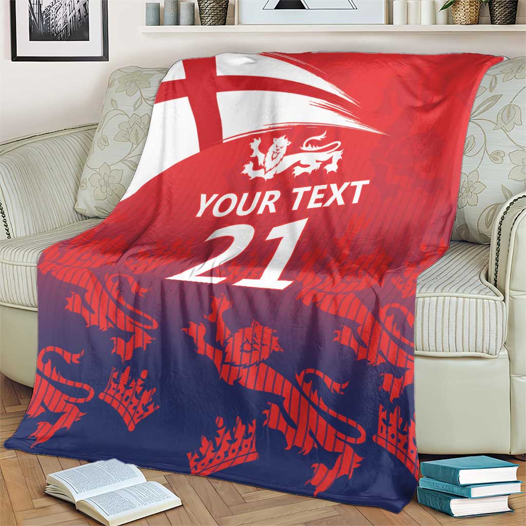 Red and dark blue cricket blanket with England flag, lion crest, and '21' on couch