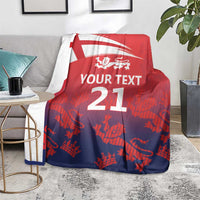 Red cricket blanket with England flag, lion crest and '21' on gray sofa