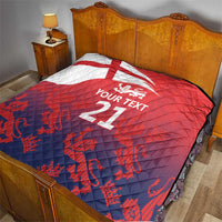 Red and navy quilt with Union Jack, lion crest, and 'YOUR TEXT 21' on bed bedding