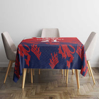 Red and navy cricket tablecloth with lion-and-flag pattern on dining table