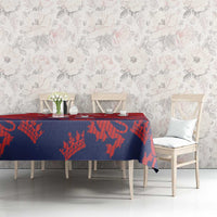 Red and navy cricket tablecloth with lion-and-flag pattern on dining table