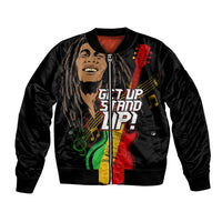 Black bomber jacket with multicolored graphic of face, guitar, and music notes