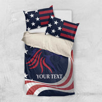 Patriotic bedding set laid flat: blue comforter with stars and eagle graphic, two pillows