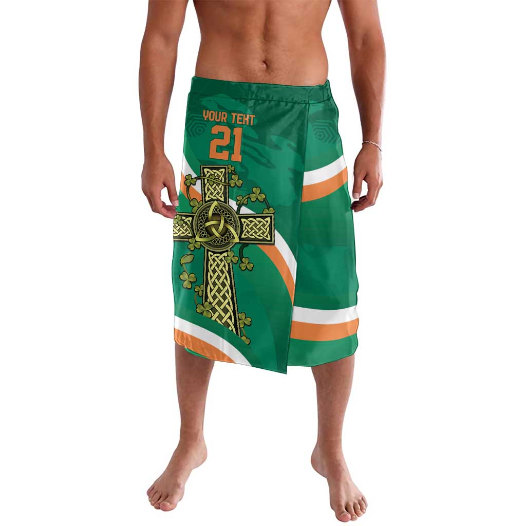 Green rugby-style swim shorts with Celtic knot panel and orange striped bands