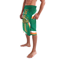 Green shorts with Celtic knot crest, orange stripe trim, and elastic waistband