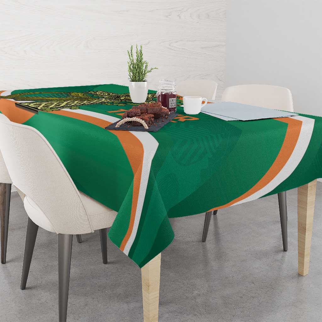 Green tablecloth on dining table with orange-and-white curved stripe