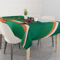 Green tablecloth on dining table with orange-and-white curved stripe