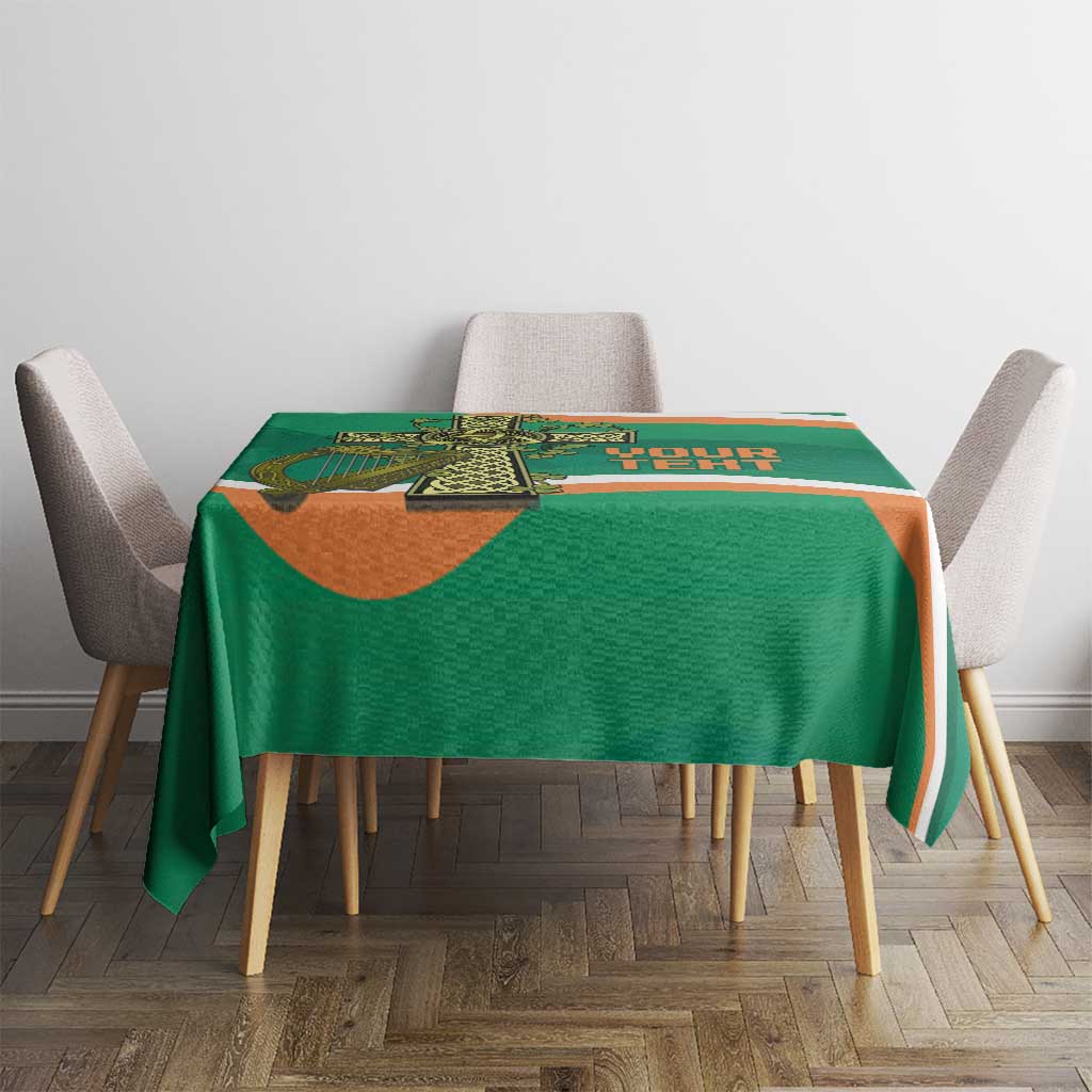 Green tablecloth with Celtic cross emblem and orange-and-white edge stripe