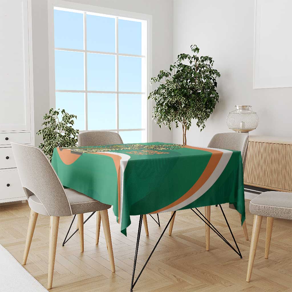 Green tablecloth on dining set with orange-and-white stripe border
