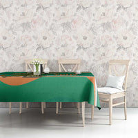 Green tablecloth on dining table with Celtic pattern along the top edge
