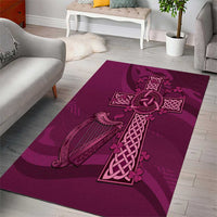 Maroon rectangular area rug featuring a Celtic knot cross and harp graphic
