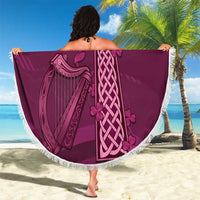 Maroon round beach blanket with white fringe, Celtic cross knot and harp design held out