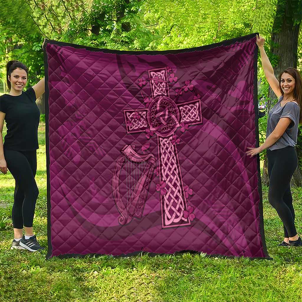 Maroon Celtic knot quilt featuring a large cross design on quilted diamond fabric