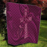 Maroon quilt with quilted diamond texture and Celtic knot cross centerpiece
