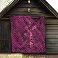 Maroon quilt with centered Celtic knot cross on quilted diamond pattern