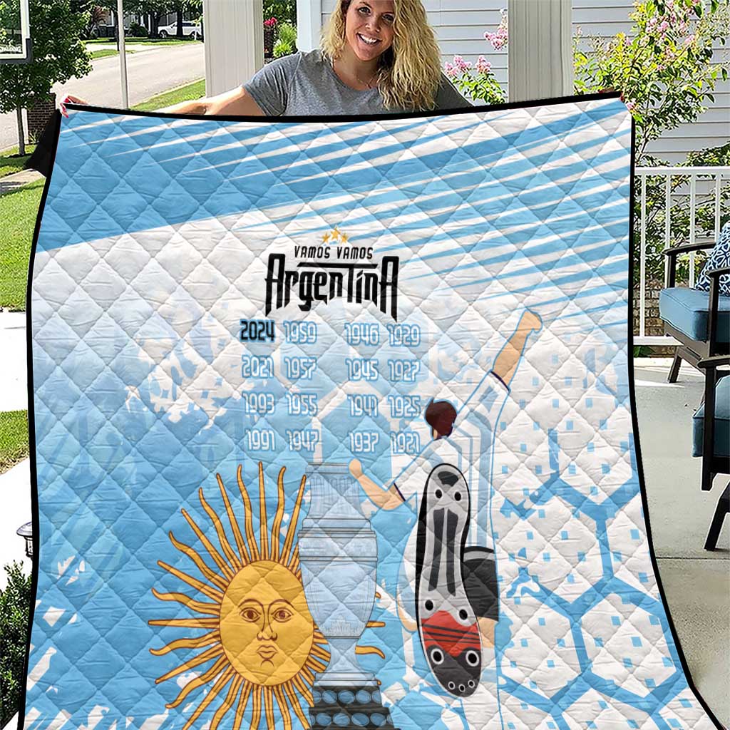 Blue Argentina football quilt blanket held outside, sun emblem and soccer figures graphic