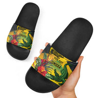 Black slide sandals with tropical crocodile band; worn look held by hand