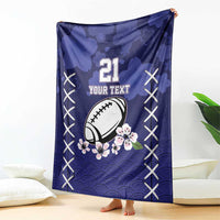 Blue rugby blanket, football and cherry blossoms, number 21 text, X-stitch border
