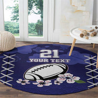 Blue round rugby-themed area rug with “21” and football, floral accents and crisscross stitching